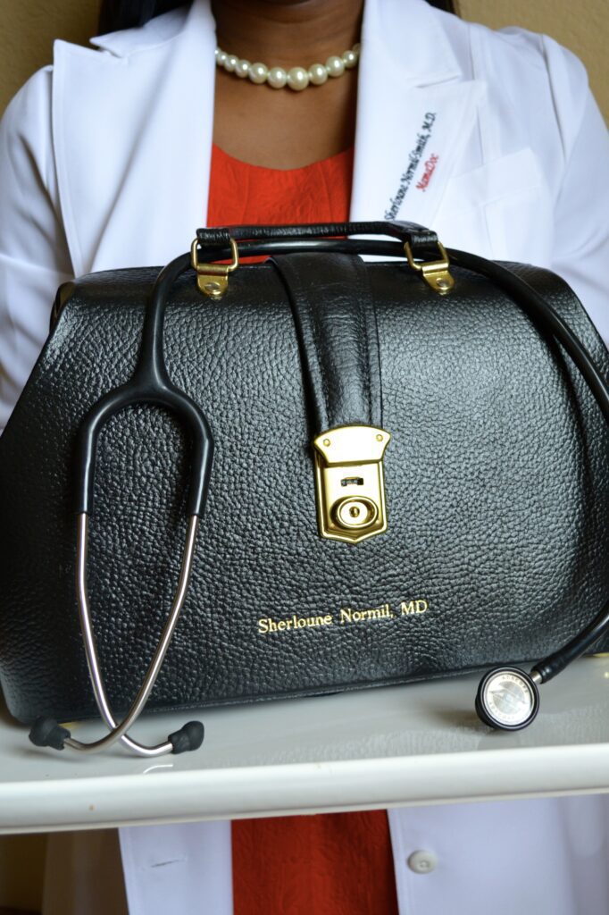 Close up image of a black color purse and a stethoscope