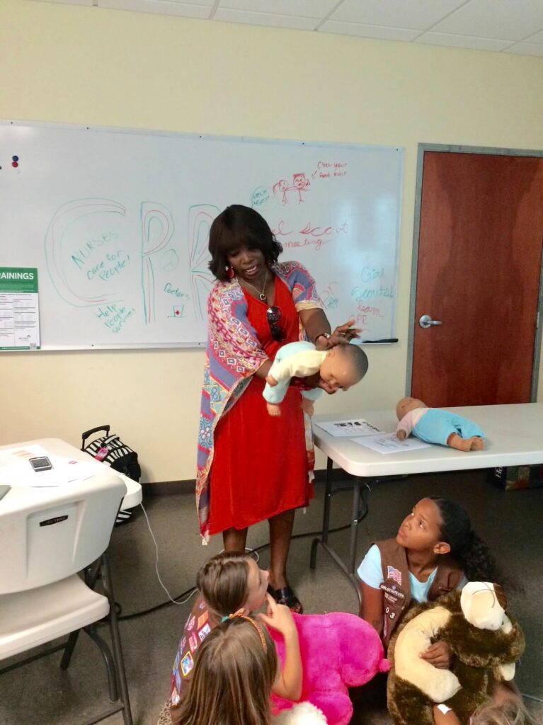 A girl playing with some small children