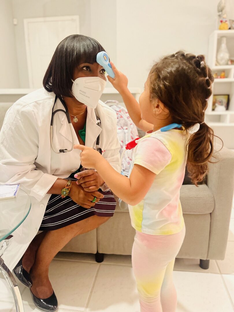 A small girl playing with a doctor with machine