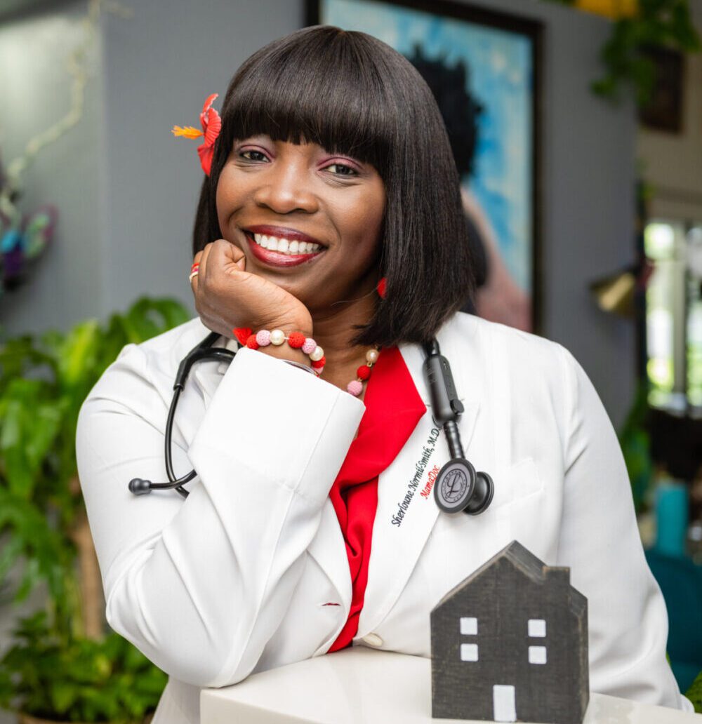 A doctor with a stethoscope smiling at the camera