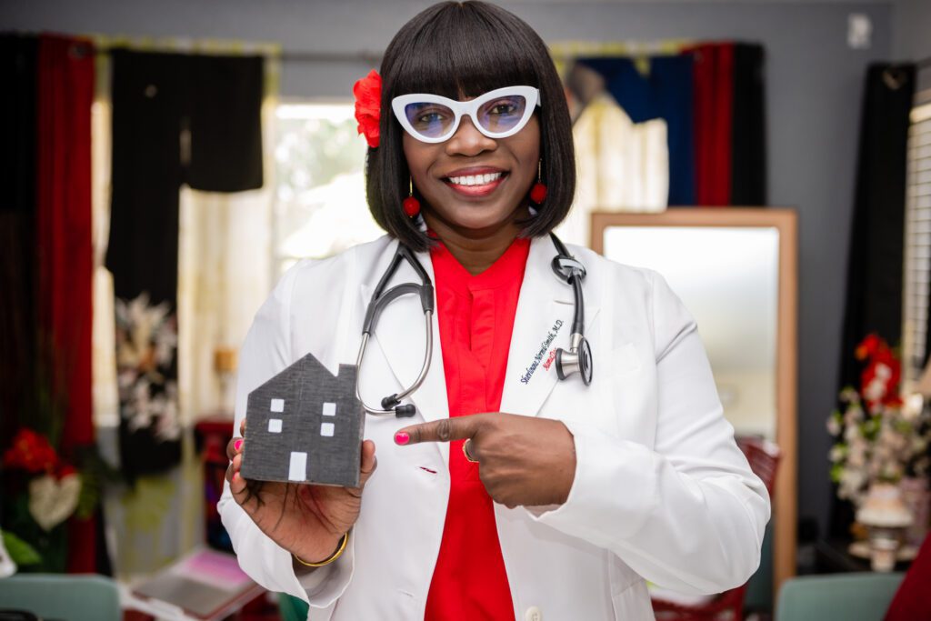 A doctor holding a gray color house