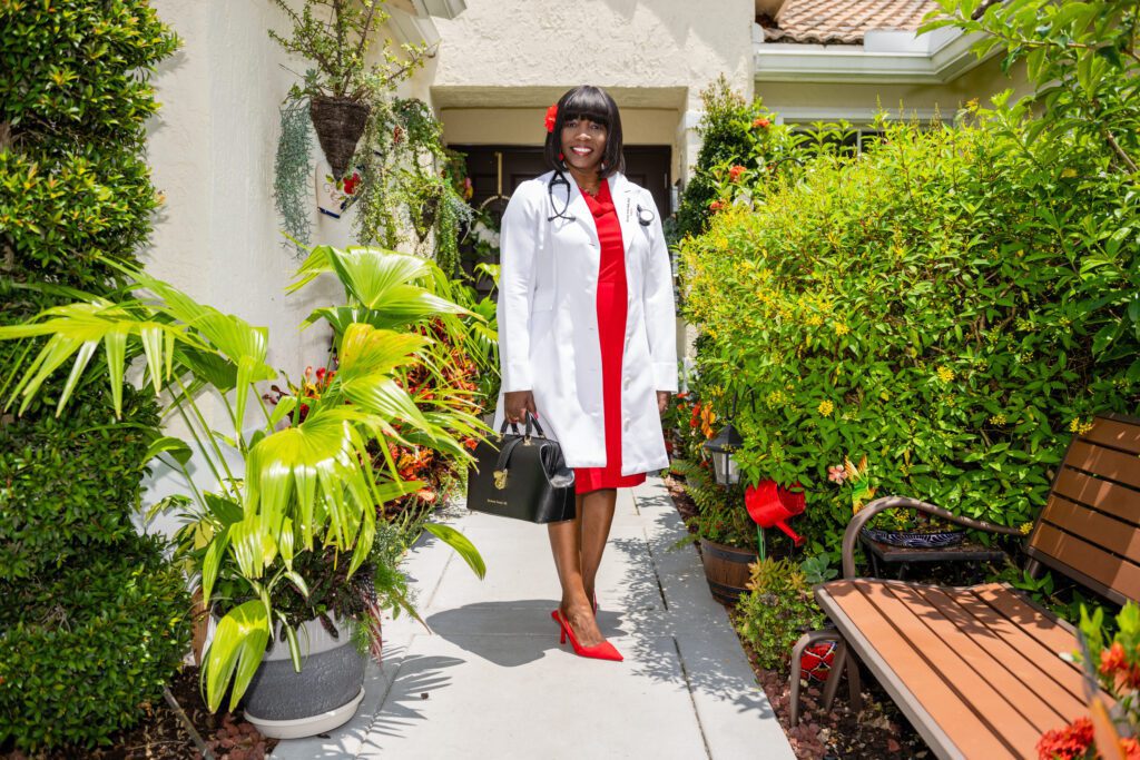 A girl wearing a red dress and a white coat