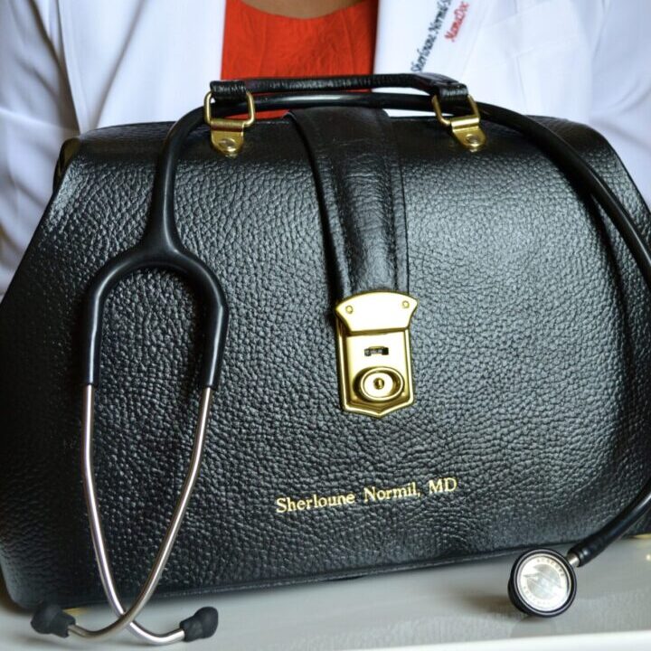 Close up image of a black color purse and a stethoscope