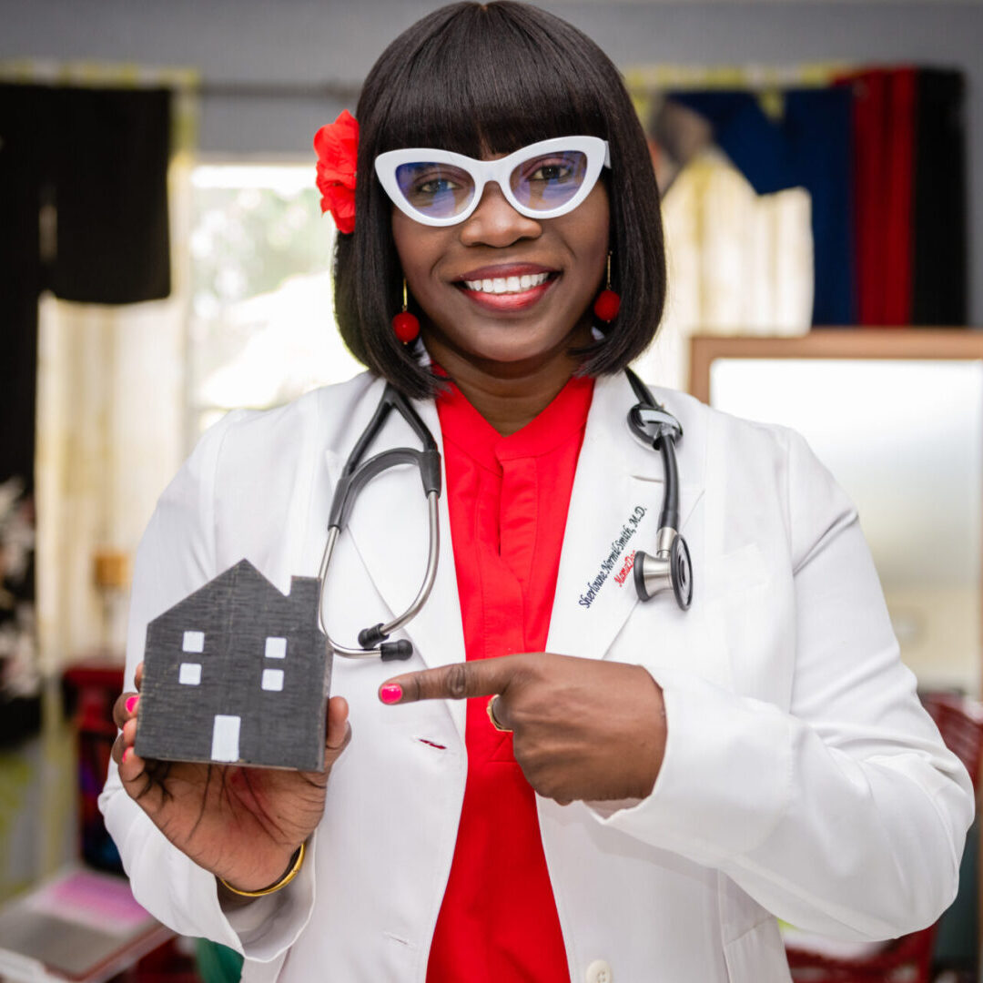 A doctor holding a gray color house