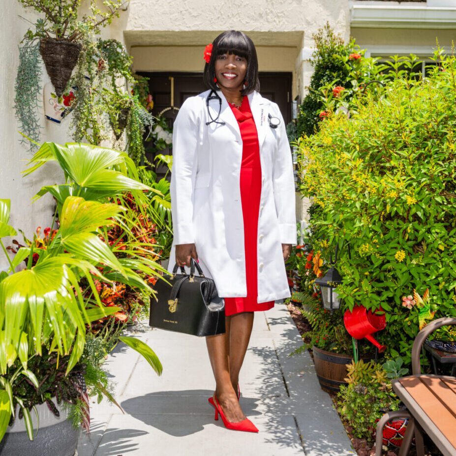 A girl wearing a red dress and a white coat